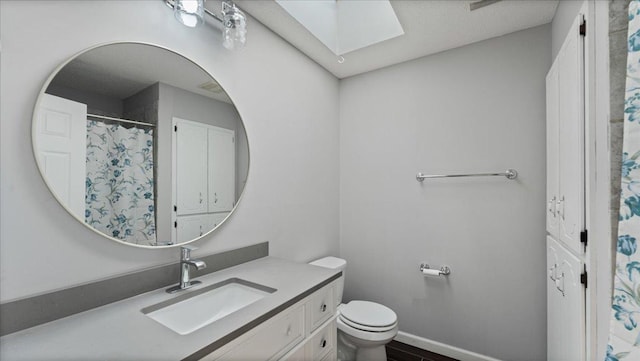 12720 Ibis St NW, Coon Rapids, MN 55448 - bathroom featuring a skylight and vanity