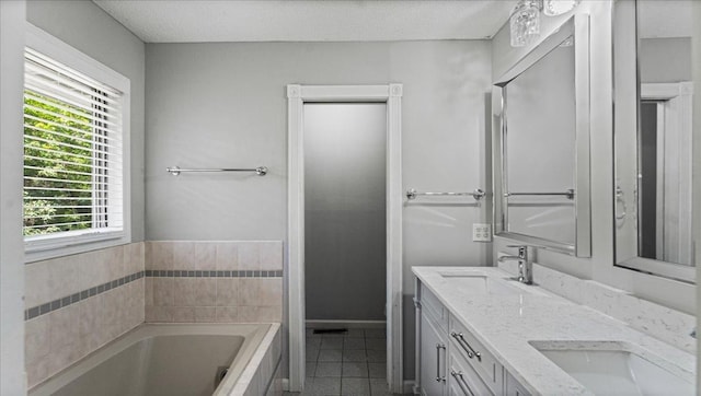 12720 Ibis St NW, Coon Rapids, MN 55448 - full bathroom with tile patterned flooring, a bath, and double vanity