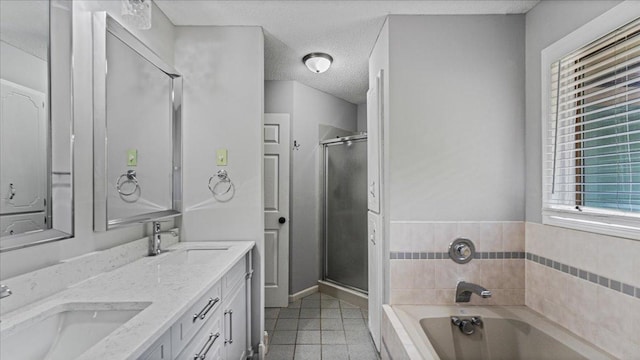 12720 Ibis St NW, Coon Rapids, MN 55448 - full bath with a garden tub, tile patterned flooring, double vanity, a shower stall, and a textured ceiling