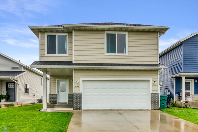 401 7th St E, Horace, ND 58047 - view of front of home with an attached garage, driveway, a front yard, and brick siding