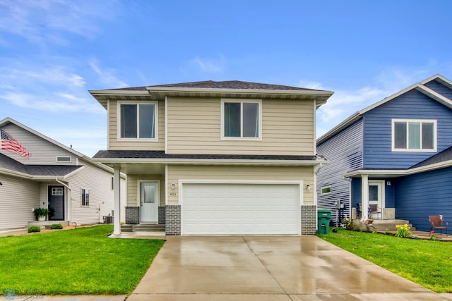 401 7th St E, Horace, ND 58047 - view of front of home with an attached garage, driveway, a front lawn, and brick siding