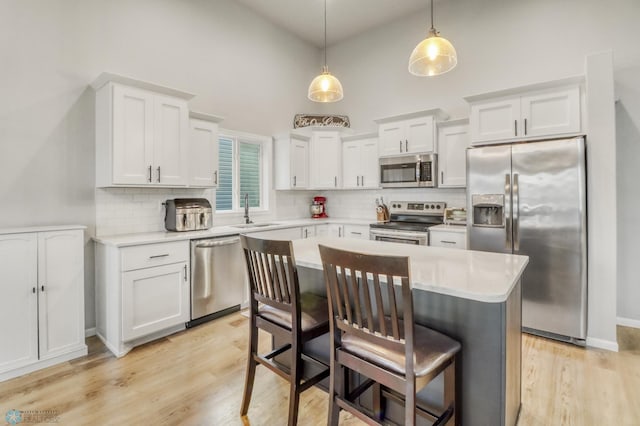 401 7th St E, Horace, ND 58047 - kitchen featuring stainless steel appliances, light countertops, decorative backsplash, white cabinetry, and high vaulted ceiling