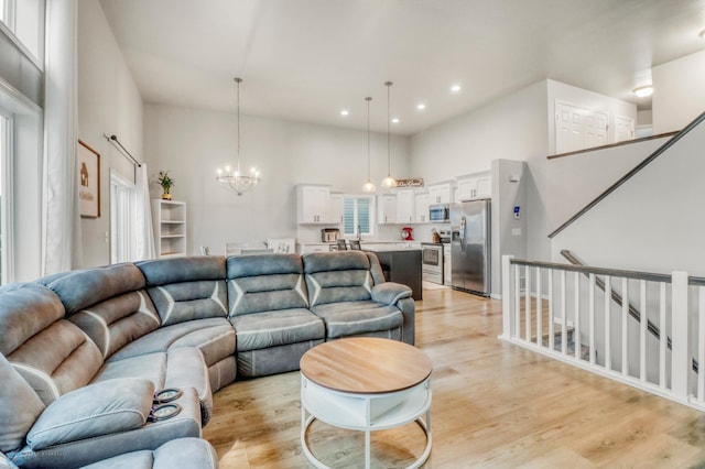 401 7th St E, Horace, ND 58047 - living room featuring a chandelier, light wood-style floors, recessed lighting, and a towering ceiling
