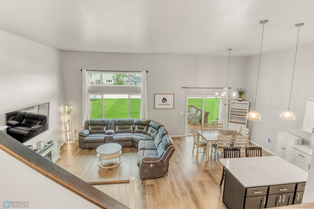 401 7th St E, Horace, ND 58047 - living room featuring a chandelier, light wood-style floors, and plenty of natural light
