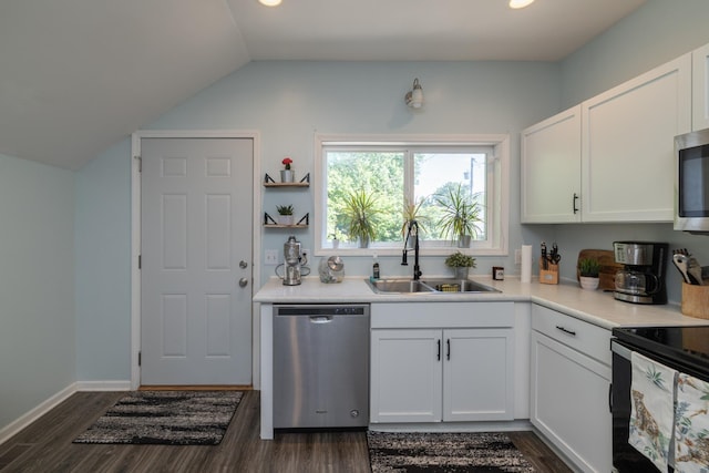 700 6th St E, Saint Paul, MN 55106 - kitchen with appliances with stainless steel finishes, dark wood-style floors, lofted ceiling, white cabinets, and light countertops