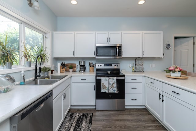 700 6th St E, Saint Paul, MN 55106 - kitchen with stainless steel appliances, white cabinets, light countertops, recessed lighting, and dark wood-type flooring