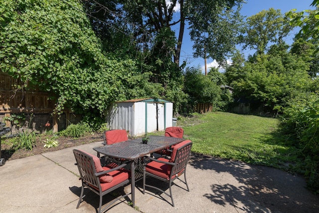 700 6th St E, Saint Paul, MN 55106 - fenced backyard with a patio area, a storage shed, and outdoor dining area