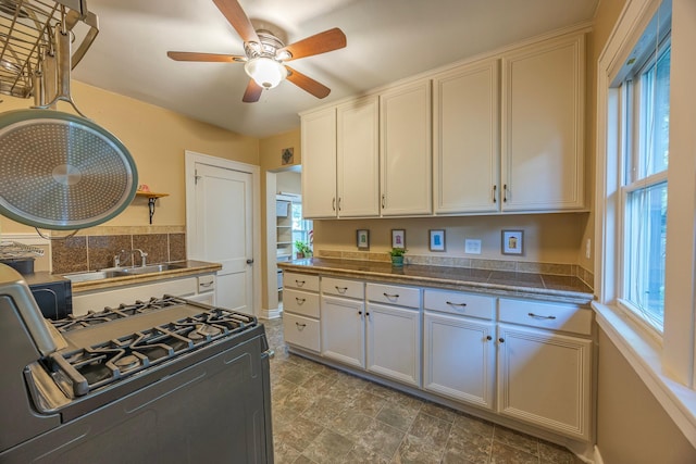 5229 42nd Ave S, Minneapolis, MN 55417 - kitchen with range with gas stovetop, a ceiling fan, tile countertops, and white cabinets
