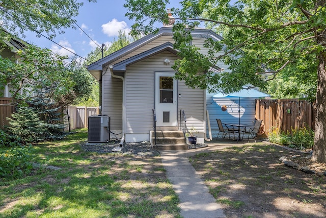 5229 42nd Ave S, Minneapolis, MN 55417 - rear view of house with entry steps, a fenced backyard, and a chimney