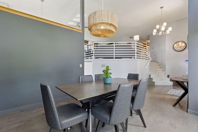18675 86th Pl N, Maple Grove, MN 55311 - dining room with wood finished floors, a chandelier, and stairs