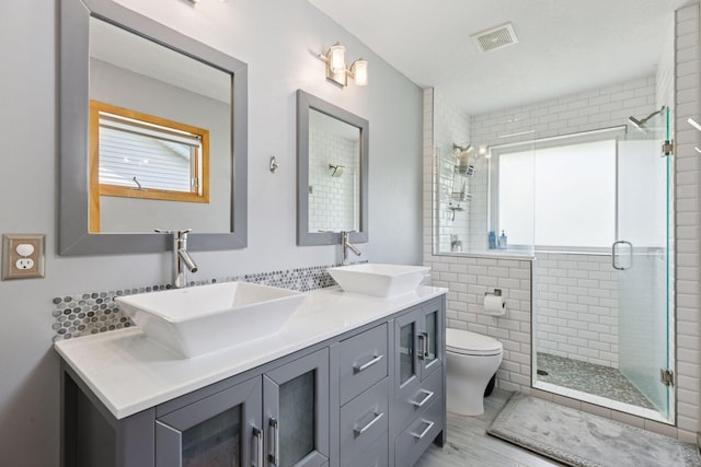 18675 86th Pl N, Maple Grove, MN 55311 - full bathroom featuring double vanity, a stall shower, and tile walls