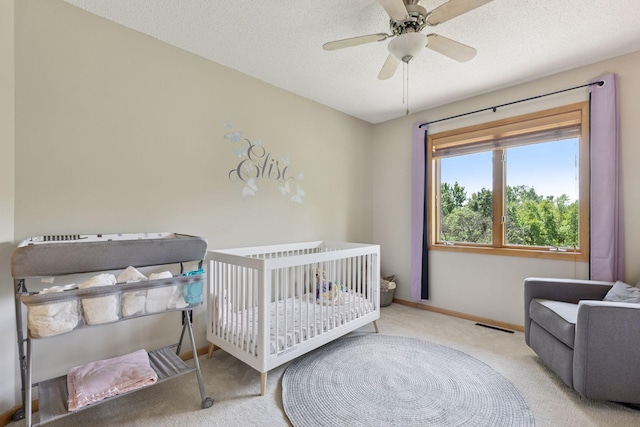 18675 86th Pl N, Maple Grove, MN 55311 - bedroom with carpet flooring, a nursery area, a ceiling fan, and a textured ceiling