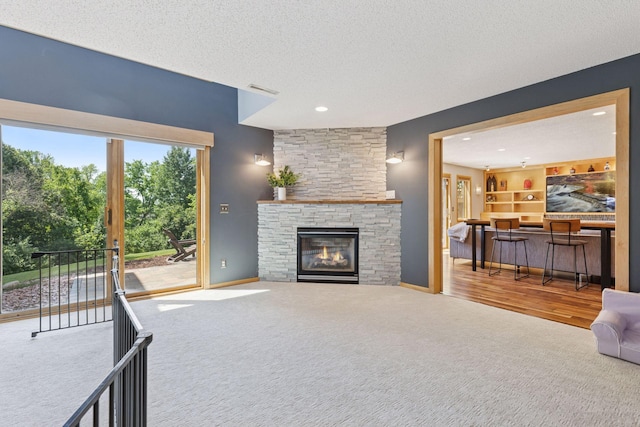 18675 86th Pl N, Maple Grove, MN 55311 - carpeted living room with a textured ceiling, a fireplace, and recessed lighting