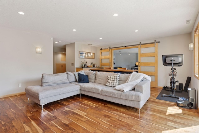 18675 86th Pl N, Maple Grove, MN 55311 - living area featuring a barn door, wood-type flooring, and recessed lighting