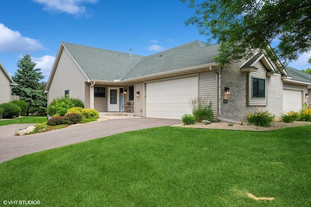 4224 93rd Ave N, Brooklyn Park, MN 55443 - view of front of home featuring a garage, driveway, a front yard, a shingled roof, and brick siding
