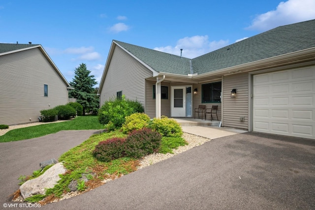 4224 93rd Ave N, Brooklyn Park, MN 55443 - view of front of property featuring an attached garage, roof with shingles, asphalt driveway, and covered porch