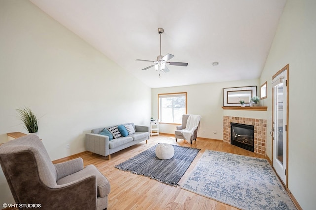 4224 93rd Ave N, Brooklyn Park, MN 55443 - living room featuring lofted ceiling, a tiled fireplace, wood finished floors, and a ceiling fan