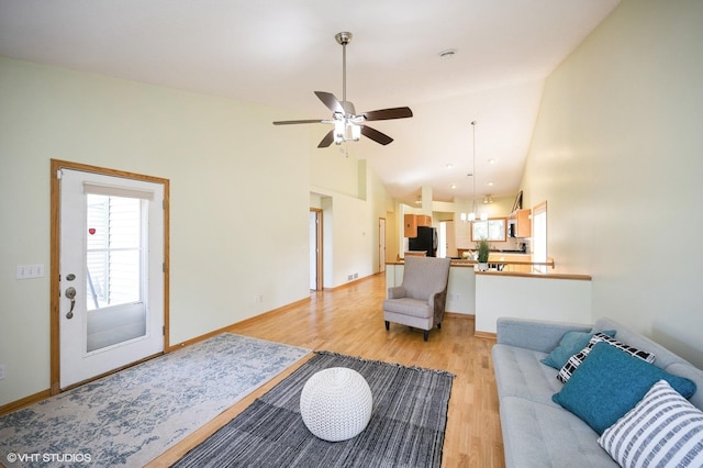 4224 93rd Ave N, Brooklyn Park, MN 55443 - living room featuring light wood-style flooring, a ceiling fan, and high vaulted ceiling
