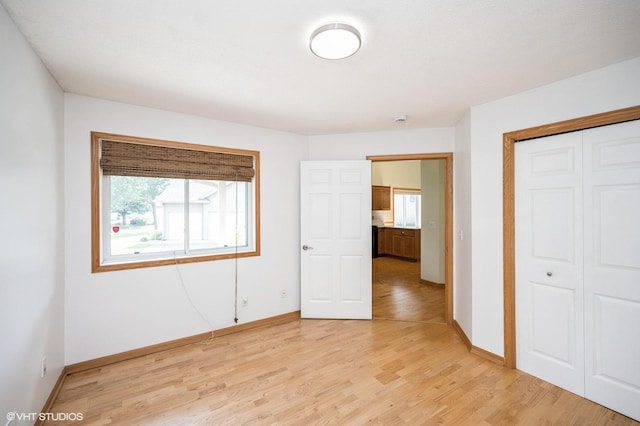 4224 93rd Ave N, Brooklyn Park, MN 55443 - unfurnished bedroom featuring light wood-type flooring and a closet