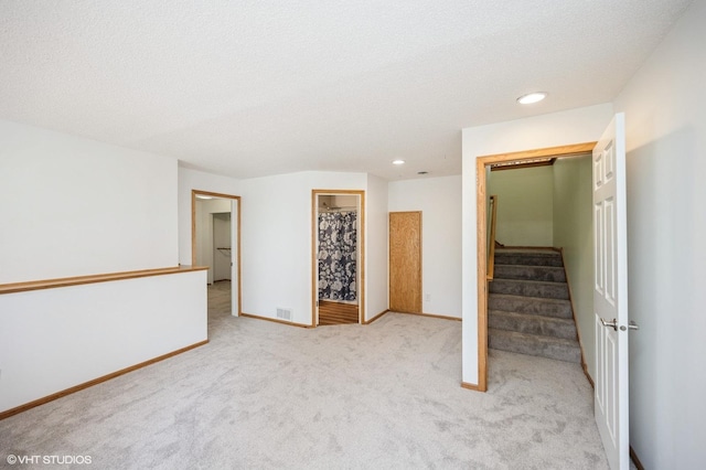 4224 93rd Ave N, Brooklyn Park, MN 55443 - spare room featuring light colored carpet, recessed lighting, and stairs