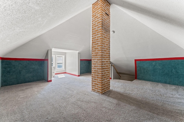 3204 5th Ave S, Minneapolis, MN 55408 - additional living space with vaulted ceiling, a textured ceiling, and carpet flooring