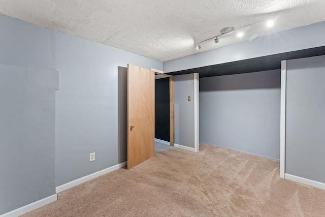 3204 5th Ave S, Minneapolis, MN 55408 - finished below grade area with carpet floors, a textured ceiling, and rail lighting