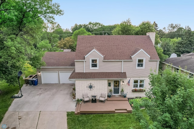 1800 Centre Sq, Moorhead, MN 56560 - view of front of house with concrete driveway, a deck, a garage, roof with shingles, and a chimney