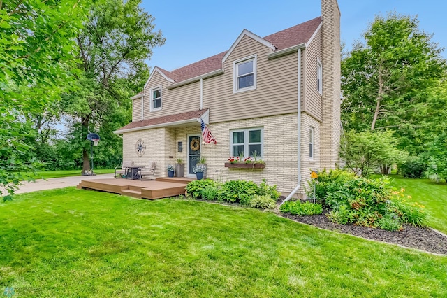 1800 Centre Sq, Moorhead, MN 56560 - view of front facade featuring a deck, a chimney, a front lawn, and roof with shingles