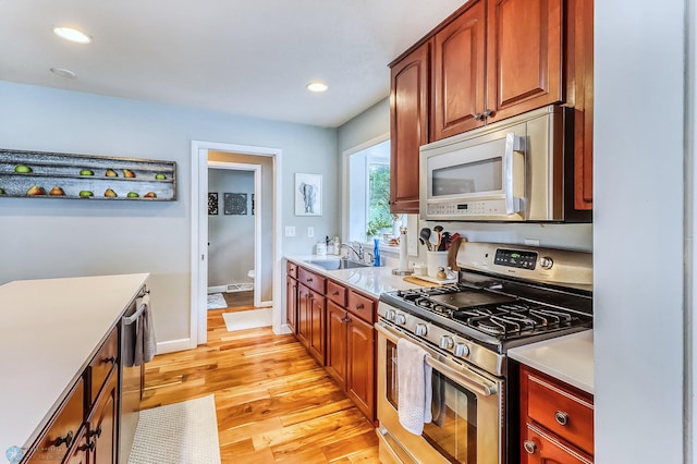 1800 Centre Sq, Moorhead, MN 56560 - kitchen featuring stainless steel gas range oven, light countertops, light wood-style floors, and recessed lighting