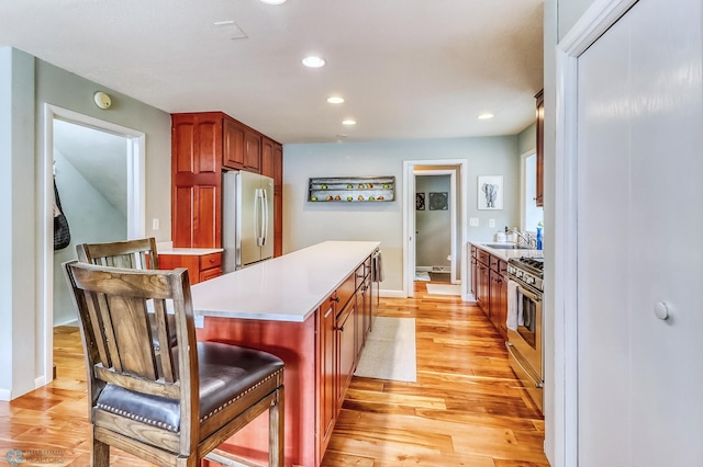 1800 Centre Sq, Moorhead, MN 56560 - kitchen featuring stainless steel appliances, light wood-style floors, light countertops, a center island, and recessed lighting