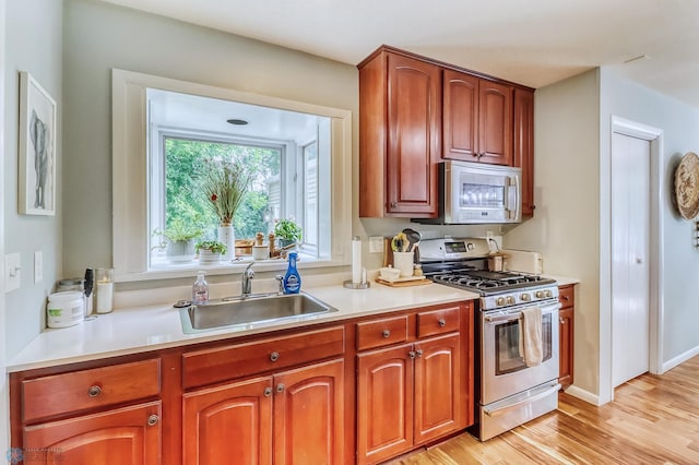 1800 Centre Sq, Moorhead, MN 56560 - kitchen featuring stainless steel appliances, light wood-style flooring, and light countertops
