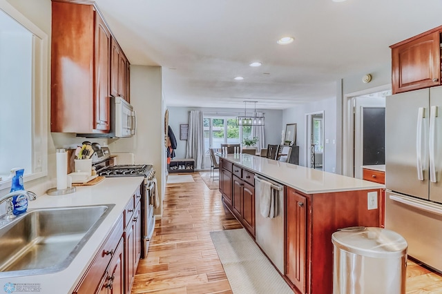 1800 Centre Sq, Moorhead, MN 56560 - kitchen featuring appliances with stainless steel finishes, recessed lighting, a center island, light countertops, and light wood-style floors