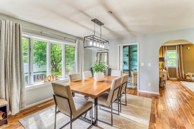 1800 Centre Sq, Moorhead, MN 56560 - dining room with arched walkways and light wood-type flooring
