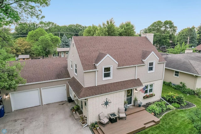 1800 Centre Sq, Moorhead, MN 56560 - view of front facade featuring a shingled roof, a garage, brick siding, a chimney, and a front yard