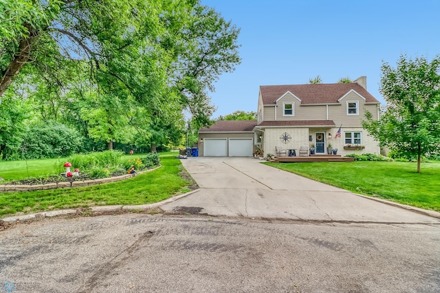 1800 Centre Sq, Moorhead, MN 56560 - traditional home featuring concrete driveway, an attached garage, a front yard, and a chimney