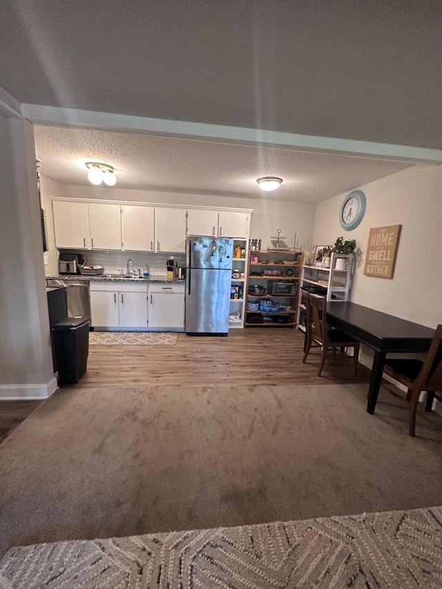 3421 Kent St Unit 607, Shoreview, MN 55126 - kitchen with freestanding refrigerator, carpet, and white cabinets