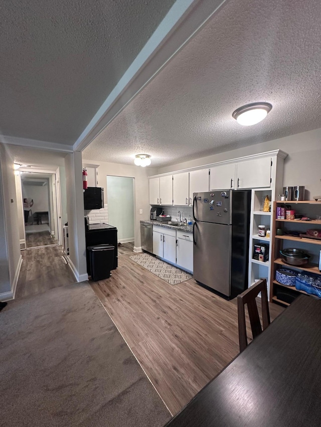 3421 Kent St Unit 607, Shoreview, MN 55126 - kitchen with appliances with stainless steel finishes, white cabinets, a textured ceiling, and light wood-style floors