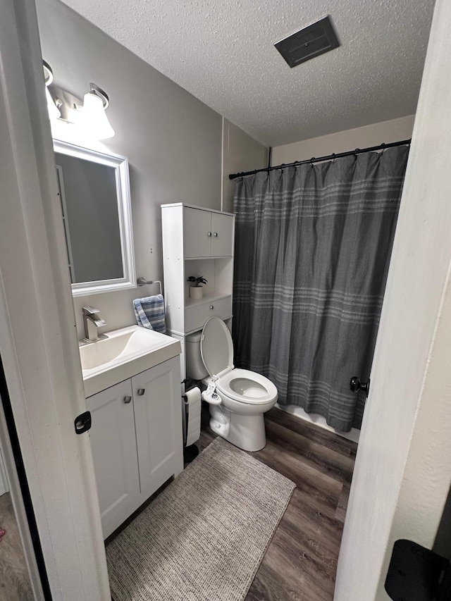 3421 Kent St Unit 607, Shoreview, MN 55126 - full bathroom featuring wood finished floors, vanity, a textured ceiling, and a shower with curtain
