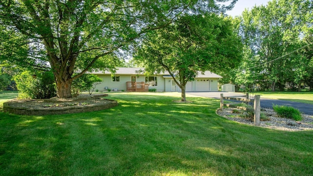 108 Viking Dr, Colfax, WI 54730 - view of grassy yard featuring a garage and concrete driveway