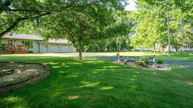108 Viking Dr, Colfax, WI 54730 - view of green lawn with a garage and a wooden deck