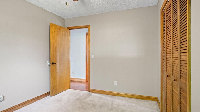 108 Viking Dr, Colfax, WI 54730 - unfurnished bedroom with a closet, carpet floors, a textured ceiling, and a ceiling fan