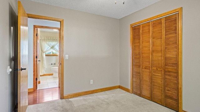 108 Viking Dr, Colfax, WI 54730 - unfurnished bedroom with a closet, a textured ceiling, and carpet