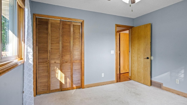 108 Viking Dr, Colfax, WI 54730 - unfurnished bedroom with a closet, carpet flooring, a textured ceiling, and a ceiling fan