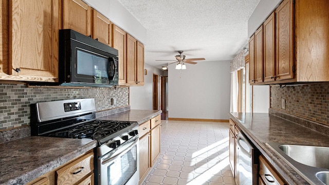 108 Viking Dr, Colfax, WI 54730 - kitchen with stainless steel appliances, decorative backsplash, ceiling fan, dark countertops, and a textured ceiling