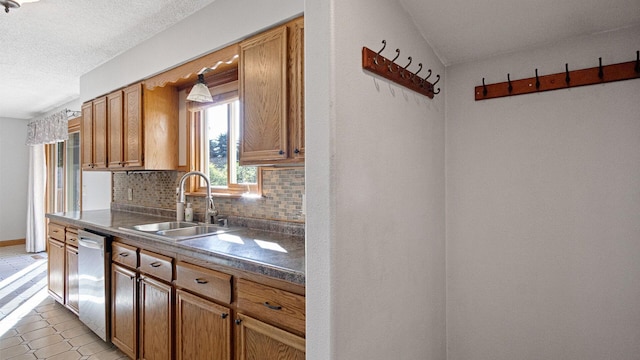 108 Viking Dr, Colfax, WI 54730 - kitchen with dark countertops, tasteful backsplash, dishwasher, and brown cabinetry