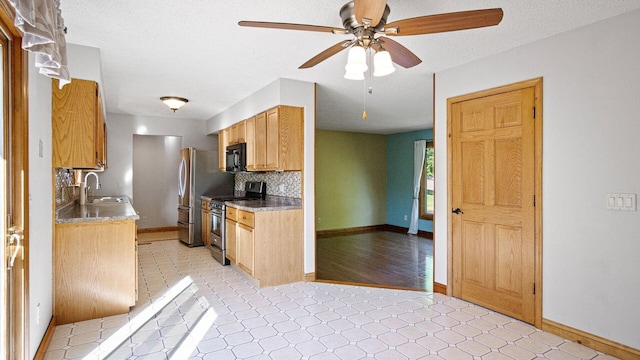 108 Viking Dr, Colfax, WI 54730 - kitchen featuring stainless steel appliances, decorative backsplash, a ceiling fan, and a textured ceiling
