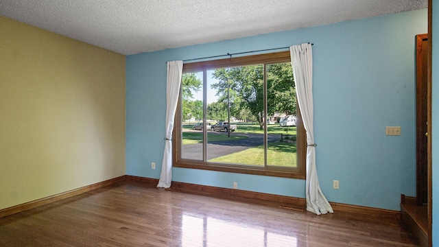 108 Viking Dr, Colfax, WI 54730 - empty room with wood finished floors and a textured ceiling