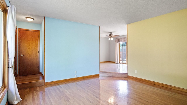108 Viking Dr, Colfax, WI 54730 - empty room with wood finished floors, a textured ceiling, and ceiling fan