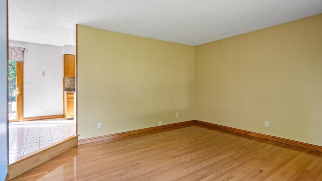 108 Viking Dr, Colfax, WI 54730 - unfurnished room with light wood-type flooring and a textured ceiling