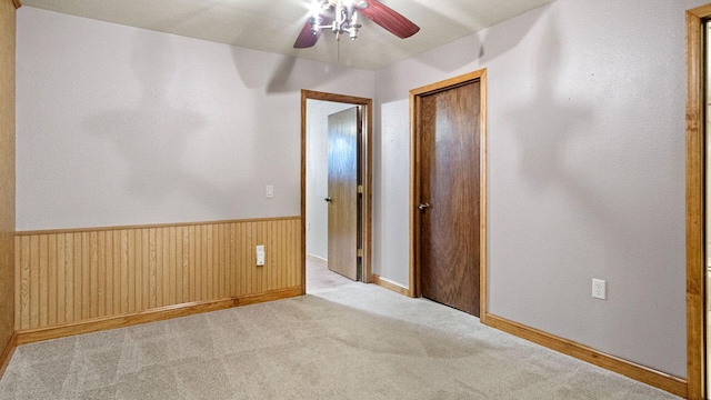 108 Viking Dr, Colfax, WI 54730 - spare room with ceiling fan, wainscoting, carpet flooring, and wooden walls